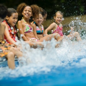 Little Kids Splashing in a Pool